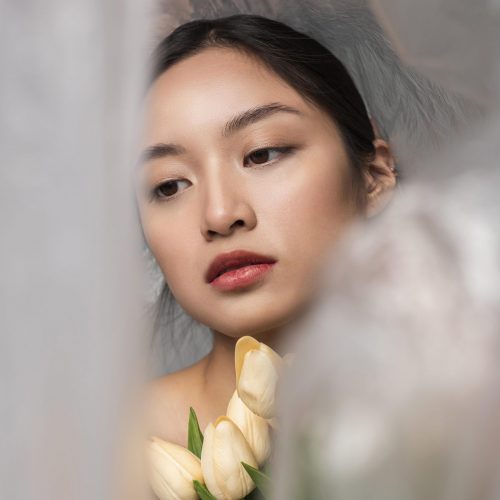 asian-woman-covered-plastic-holding-bouquet-flowers